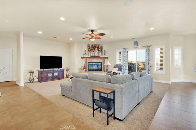 a bedroom with a bed and ceiling fan