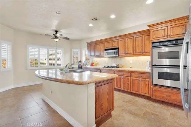 a spacious bathroom with a granite countertop sink mirror and bathtub