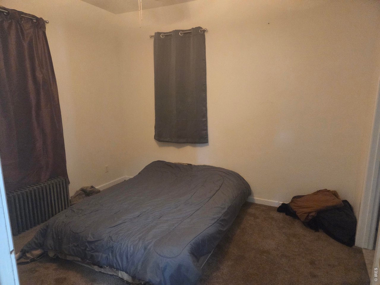533 Main Avenue Akron, CO 80720 - Photo 5 of 11 a bedroom with a bed and a dresser