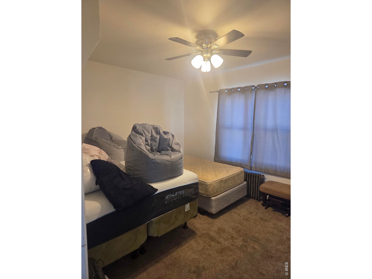 533 Main Avenue Akron, CO 80720 - Photo 8 of 11 a bedroom with a bed and a chandelier