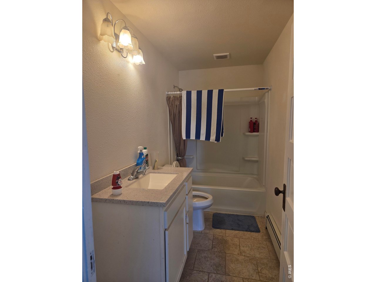 533 Main Avenue Akron, CO 80720 - Photo 9 of 11 a bathroom with a sink a mirror and a bathtub