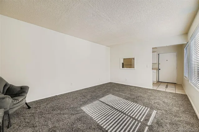 a view of a room with wooden floor and bench