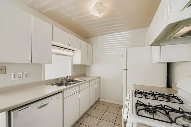 a kitchen with stainless steel appliances a white stove top oven and cabinets