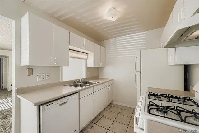 a kitchen with stainless steel appliances a stove a sink and a refrigerator