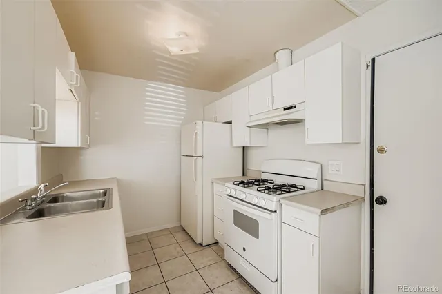 a kitchen with cabinets appliances and a window
