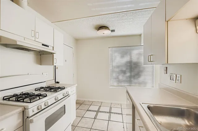 a kitchen with a stove and a sink