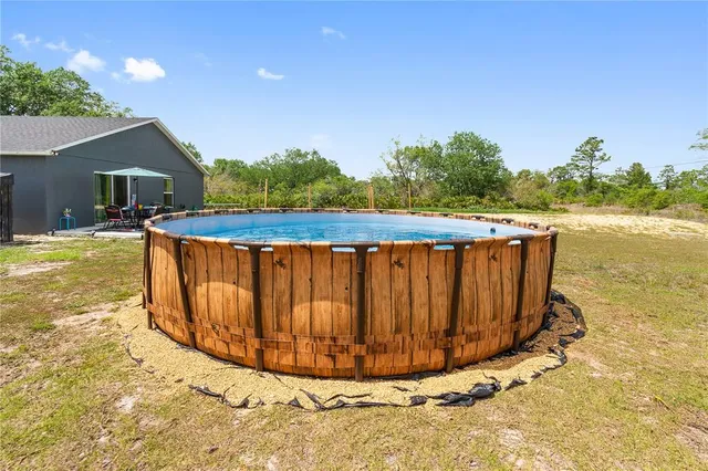 a view of swimming pool with a yard