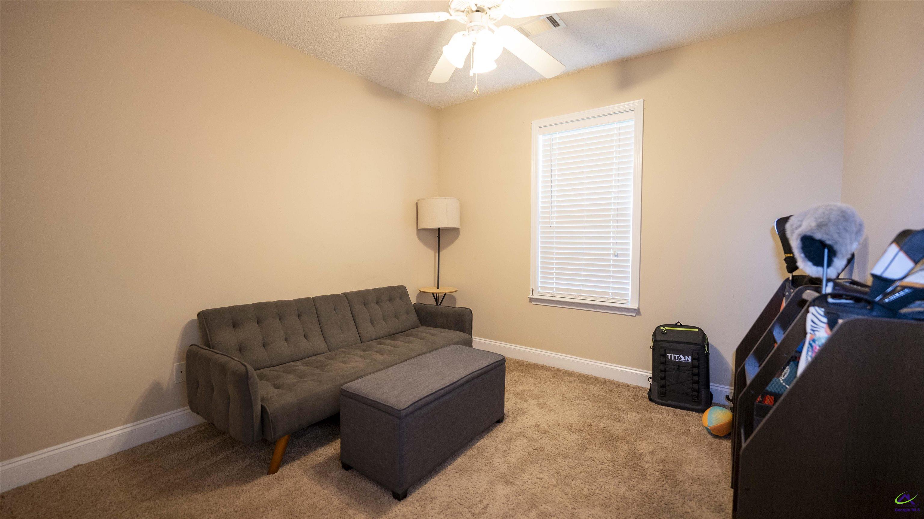 311 Sugarloaf Parkway Perry, GA 31069 - Photo 20 of 31 a living room with furniture a couch and a window