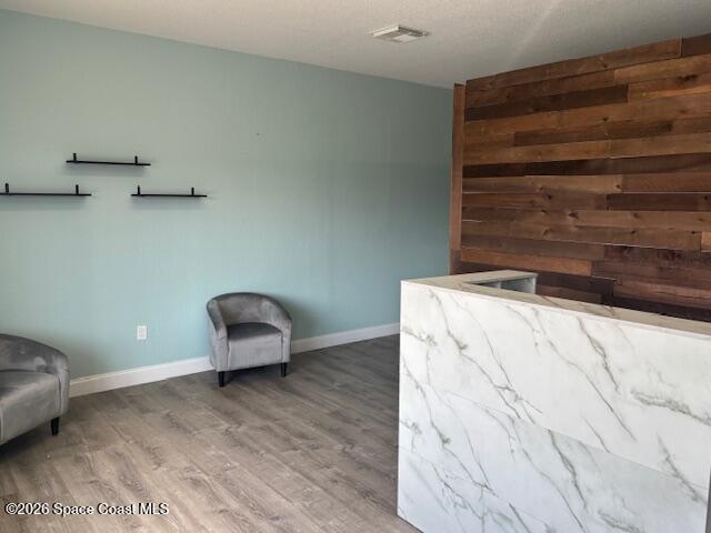 282 Clearlake Road Cocoa, FL 32922 - Photo 4 of 11 a room with a chair and a wooden floor