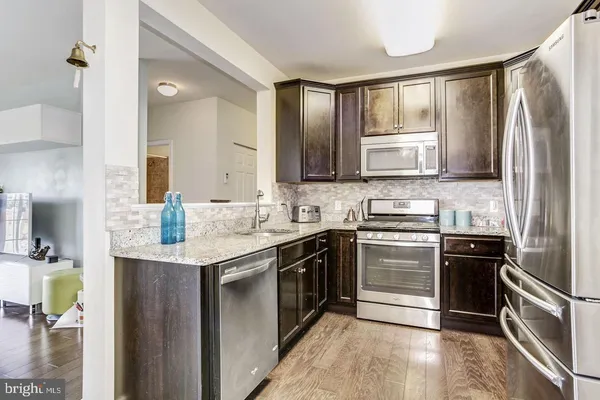 a kitchen with a sink stove and refrigerator
