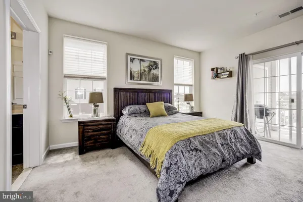 a bedroom with a bed and a large window