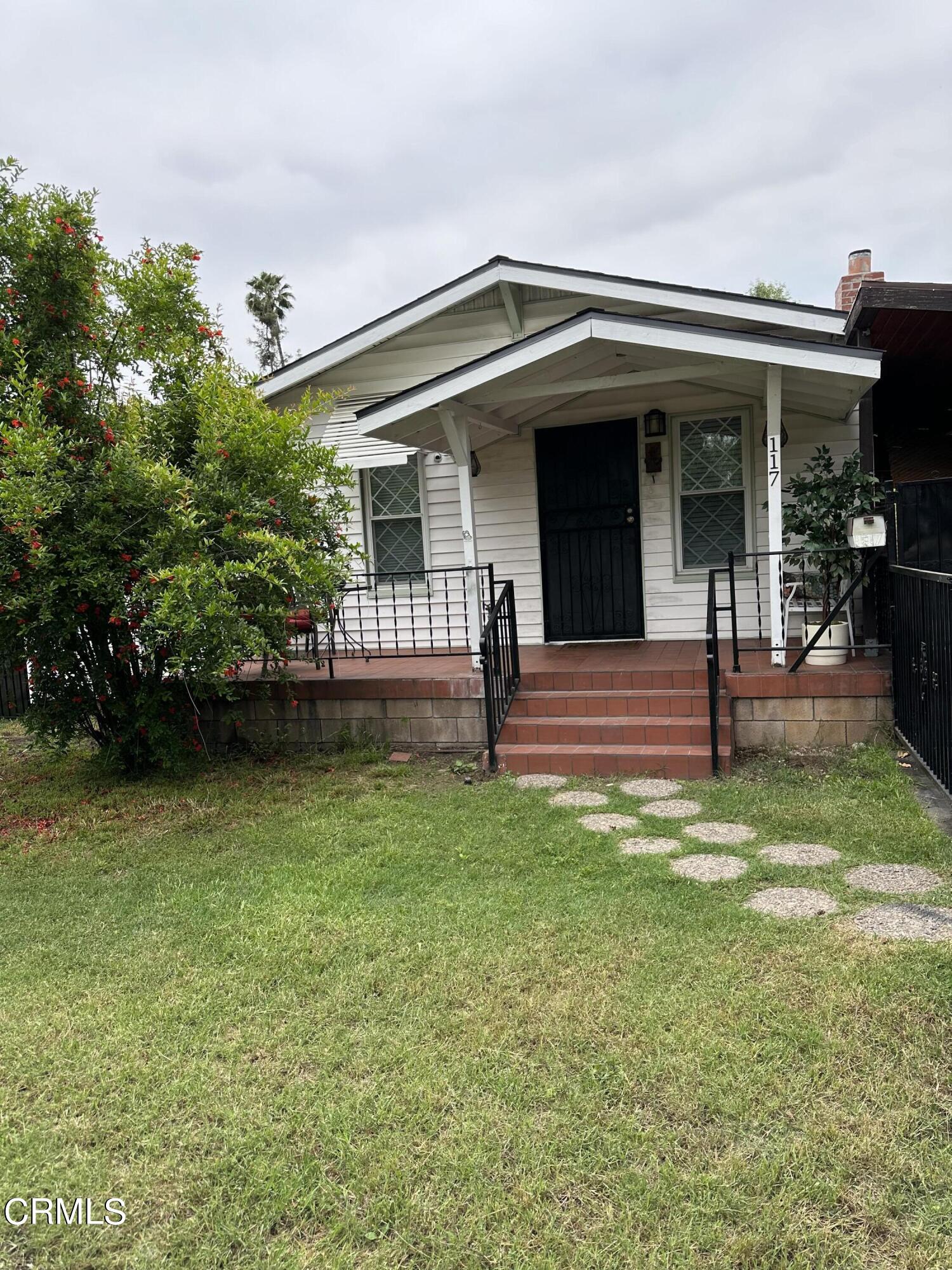 a front view of a house with garden