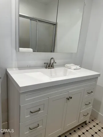 a bathroom with a sink and a mirror