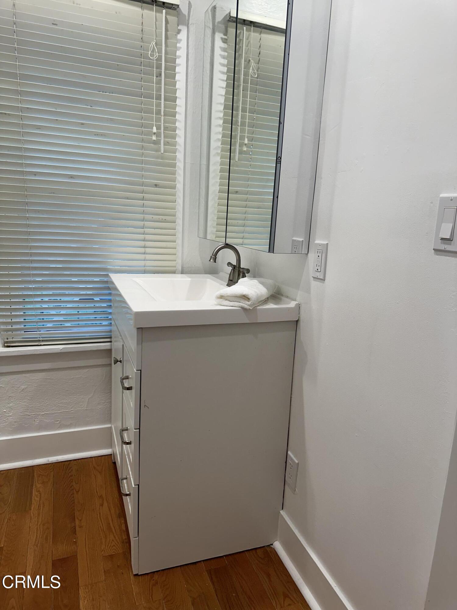 117 North Alta Vista Avenue Monrovia, CA 91016 - Photo 16 of 23 a bathroom with a sink and a mirror