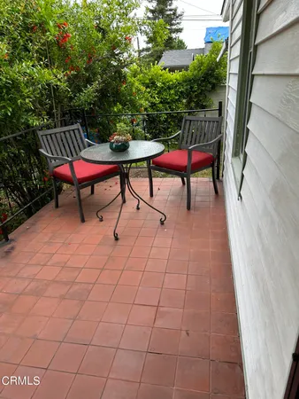 a sitting area with furniture and wooden floor