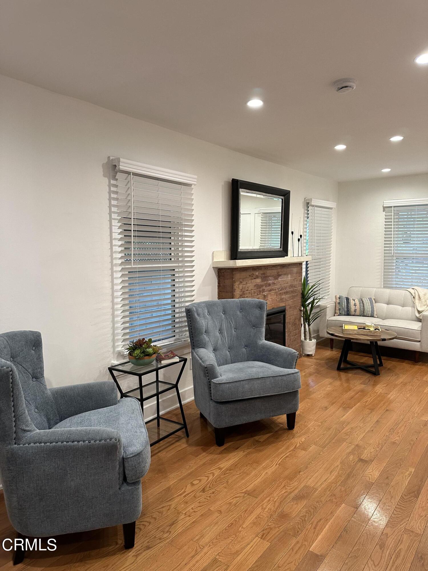 117 North Alta Vista Avenue Monrovia, CA 91016 - Photo 4 of 23 a living room with furniture and a fireplace