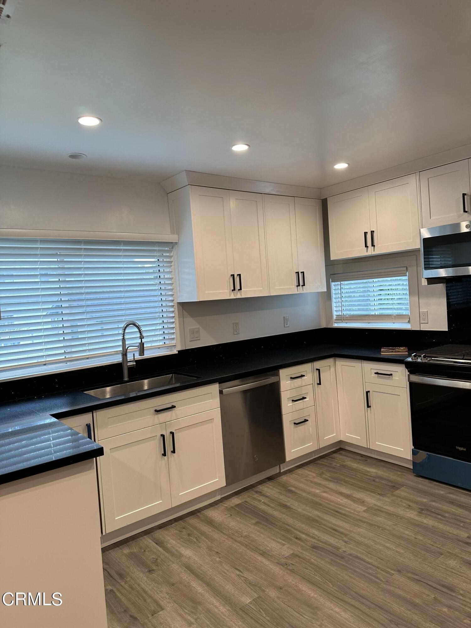 117 North Alta Vista Avenue Monrovia, CA 91016 - Photo 8 of 23 a kitchen with granite countertop a sink a stove top oven and cabinets