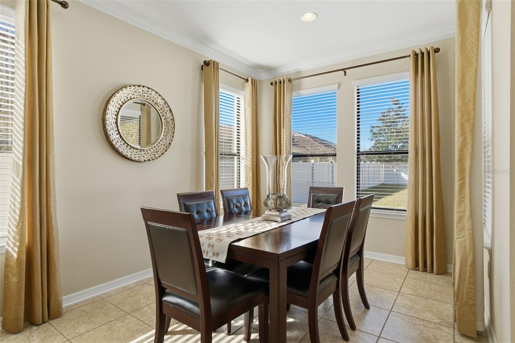 1154 Fountain Coin Loop Orlando, FL 32828 - Photo 12 of 48 a view of a dining room with furniture and a window
