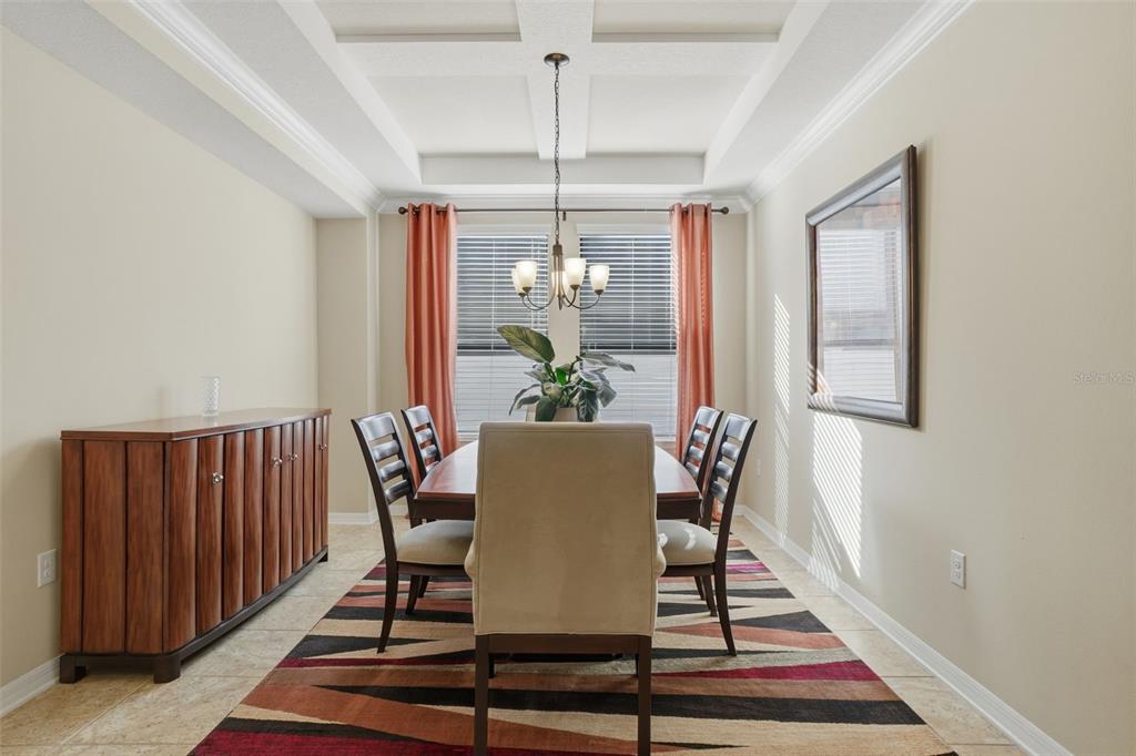 1154 Fountain Coin Loop Orlando, FL 32828 - Photo 14 of 48 a dining room with furniture a rug and wooden floor