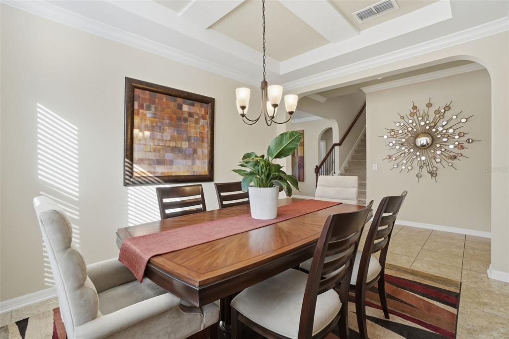 1154 Fountain Coin Loop Orlando, FL 32828 - Photo 15 of 48 a dining room with furniture a chandelier and window
