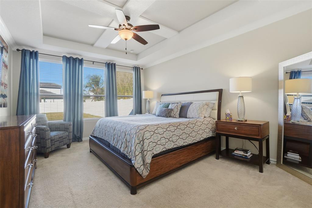 1154 Fountain Coin Loop Orlando, FL 32828 - Photo 17 of 48 a bedroom with a bed and a chandelier