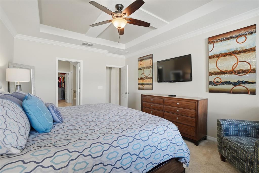 1154 Fountain Coin Loop Orlando, FL 32828 - Photo 18 of 48 a bedroom with a bed and a flat screen tv