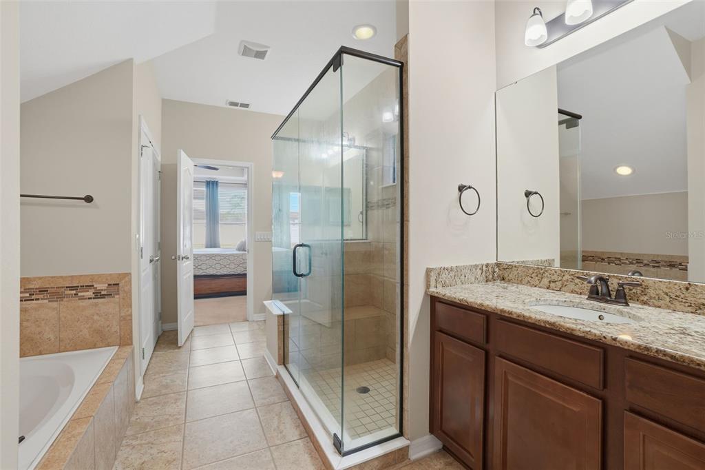 1154 Fountain Coin Loop Orlando, FL 32828 - Photo 21 of 48 a bathroom with a granite countertop sink mirror and shower