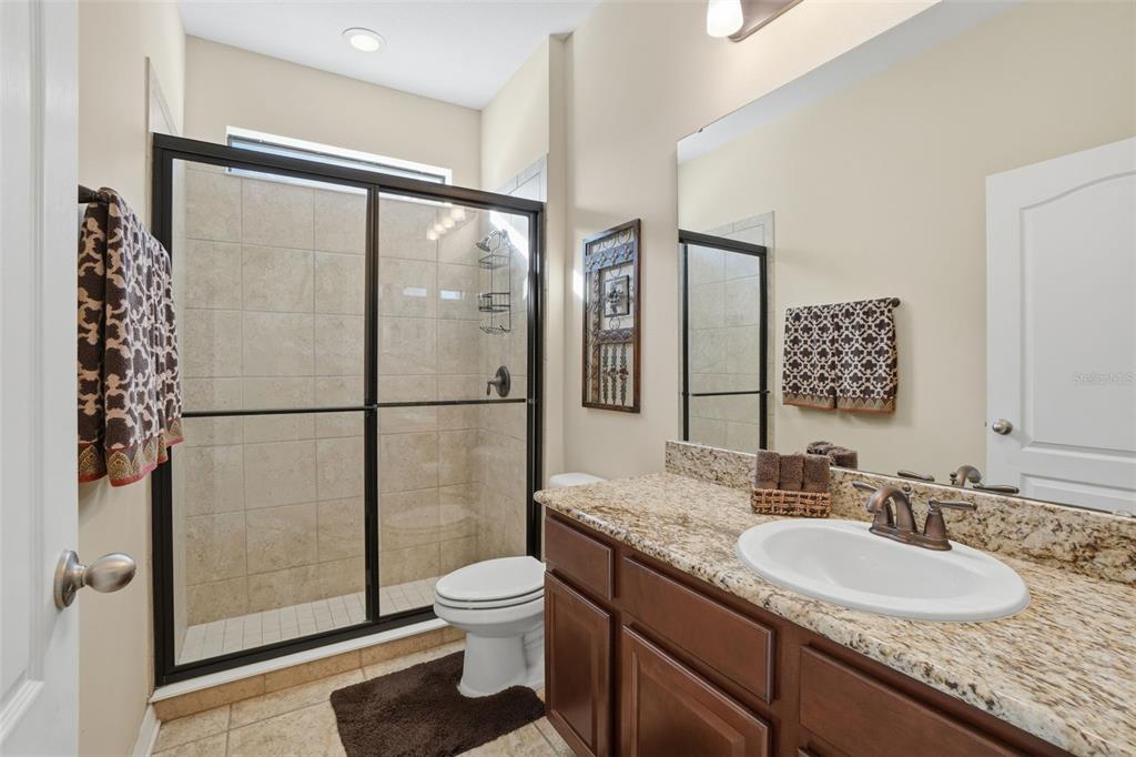 1154 Fountain Coin Loop Orlando, FL 32828 - Photo 24 of 48 a bathroom with a granite countertop sink toilet and shower