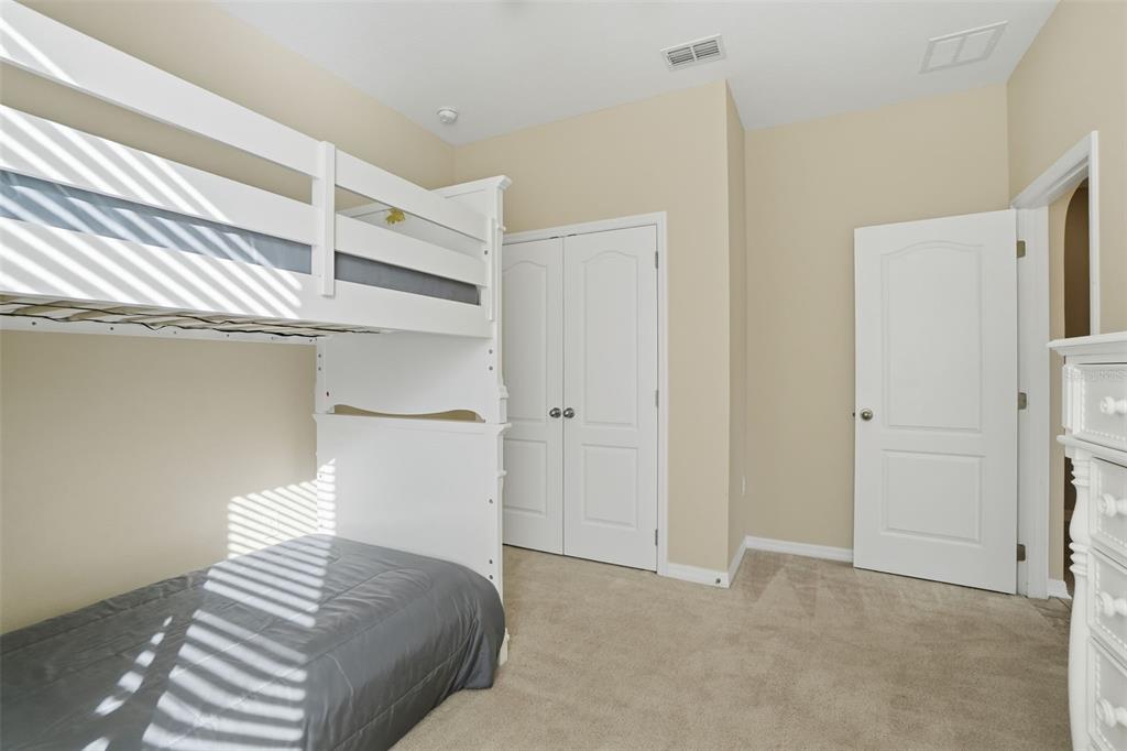 1154 Fountain Coin Loop Orlando, FL 32828 - Photo 26 of 48 a bedroom with a bed and a white cabinets