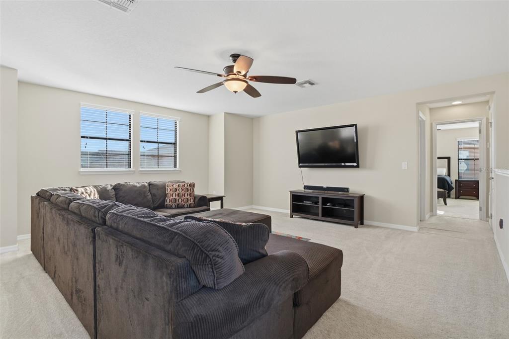 1154 Fountain Coin Loop Orlando, FL 32828 - Photo 27 of 48 a living room with furniture a flat screen tv and a window