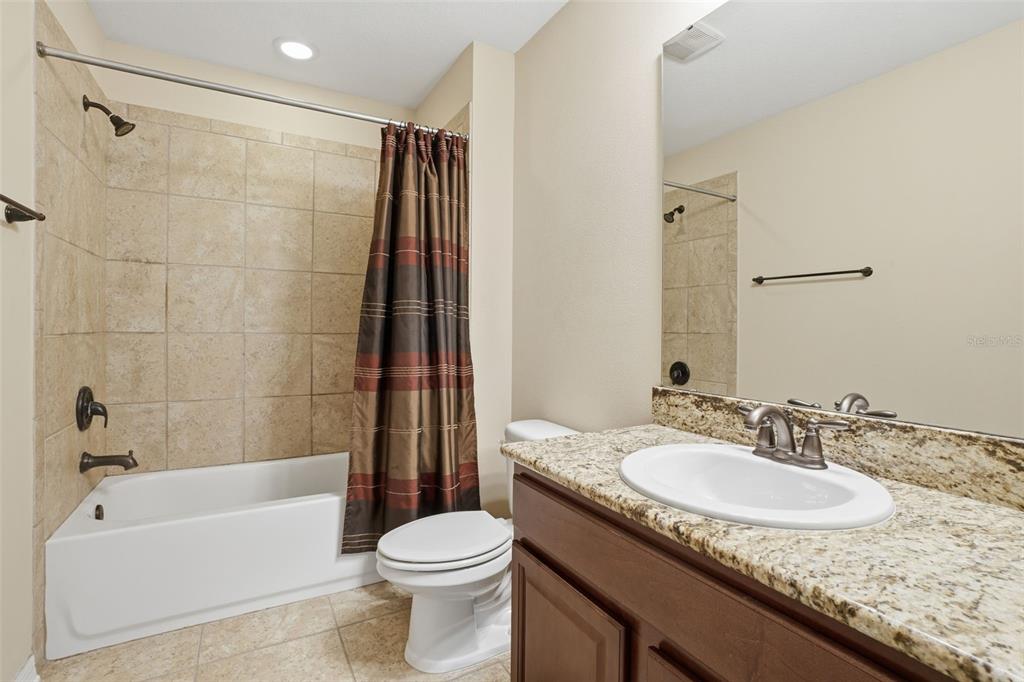 1154 Fountain Coin Loop Orlando, FL 32828 - Photo 30 of 48 a bathroom with a granite countertop sink toilet and shower