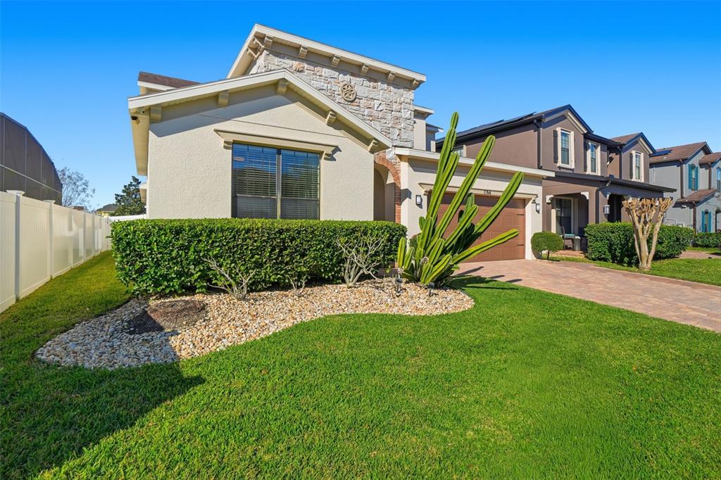 1154 Fountain Coin Loop Orlando, FL 32828 - Photo 3 of 48 a front view of a house with a yard