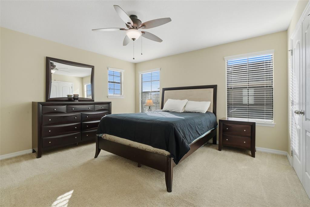 1154 Fountain Coin Loop Orlando, FL 32828 - Photo 31 of 48 a bedroom with a bed and a chandelier
