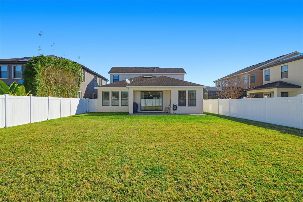 1154 Fountain Coin Loop Orlando, FL 32828 - Photo 34 of 48 a front view of a house with a garden
