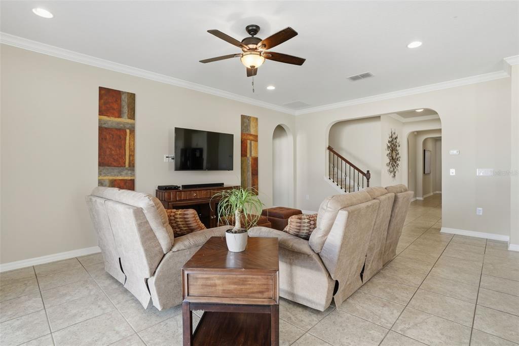 1154 Fountain Coin Loop Orlando, FL 32828 - Photo 6 of 48 a living room with furniture and a flat screen tv