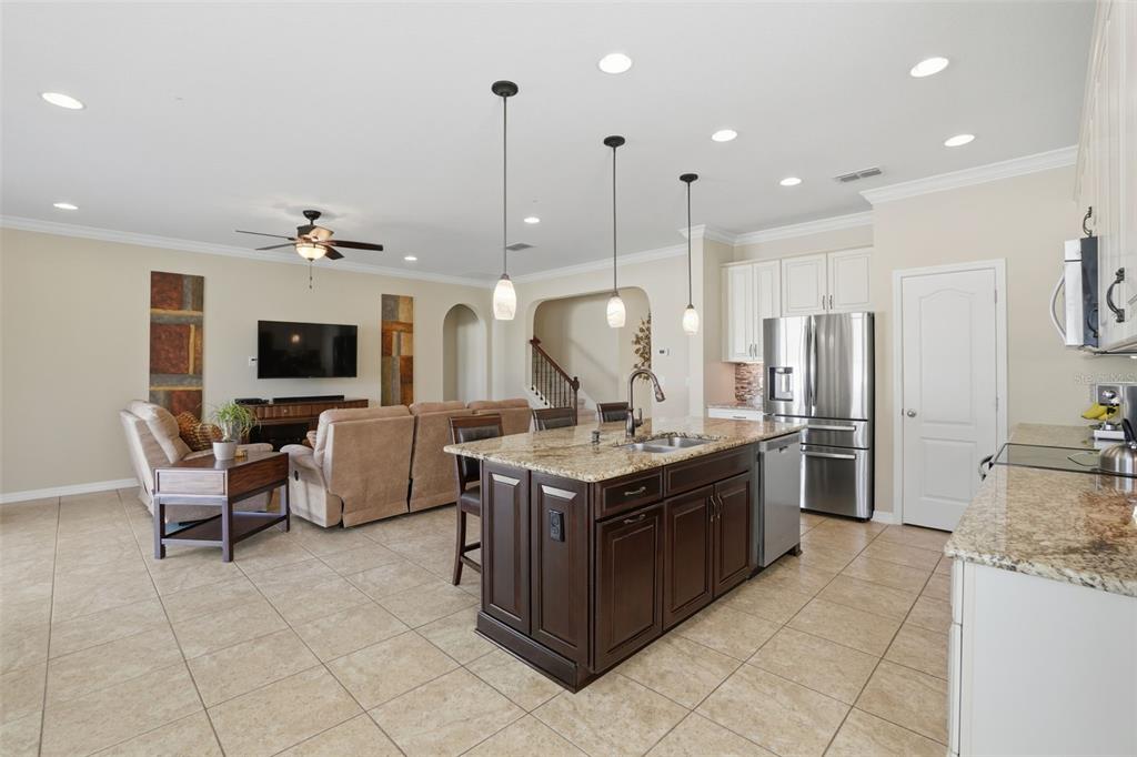 1154 Fountain Coin Loop Orlando, FL 32828 - Photo 9 of 48 a kitchen with stainless steel appliances granite countertop a stove and a sink