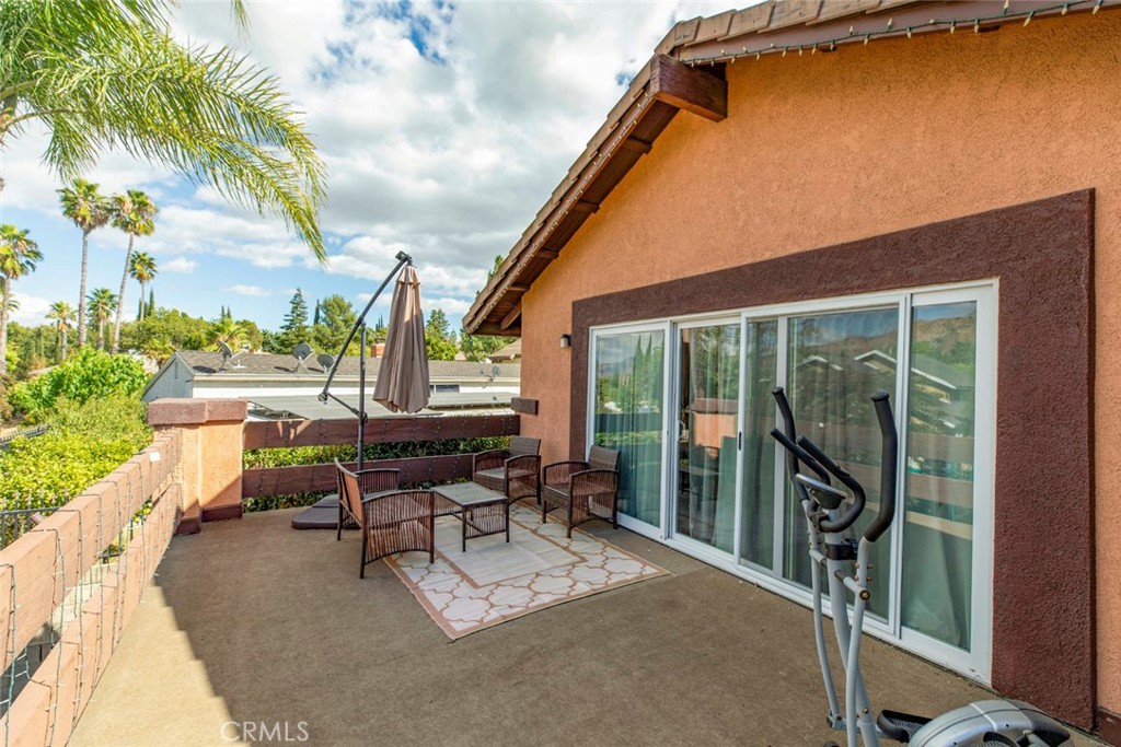 18810 Kirkcolm Lane Porter Ranch, CA 91326 - Photo 30 of 75 a building outdoor space with patio furniture and potted plants