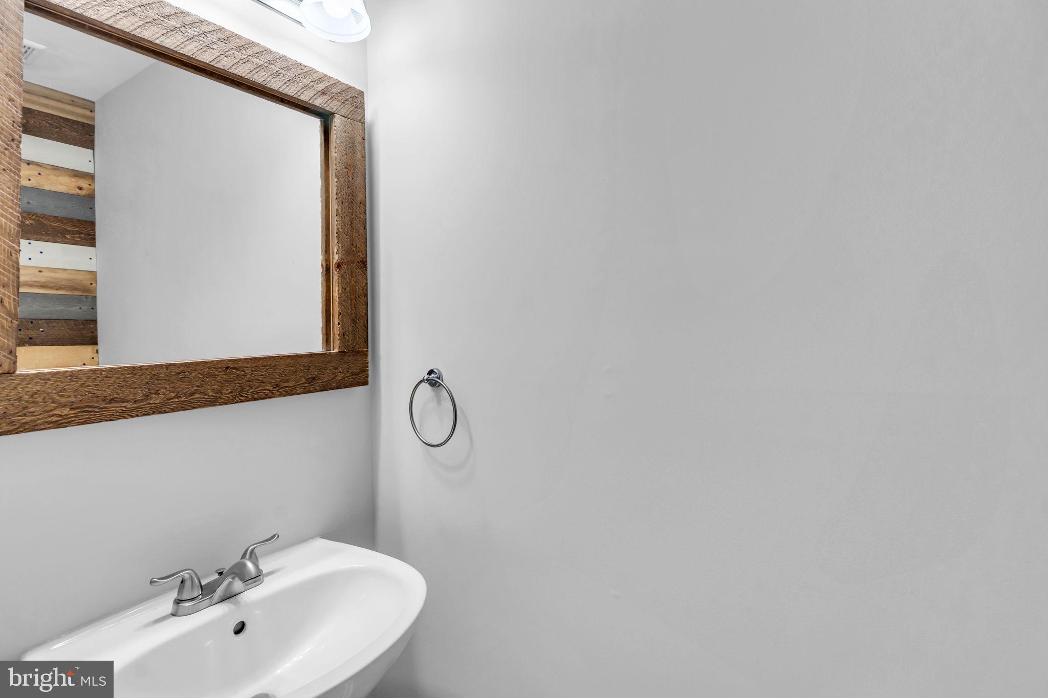 6013 Riddle Walk Alexandria, VA 22312 - Photo 14 of 31 a bathroom with a sink and a mirror