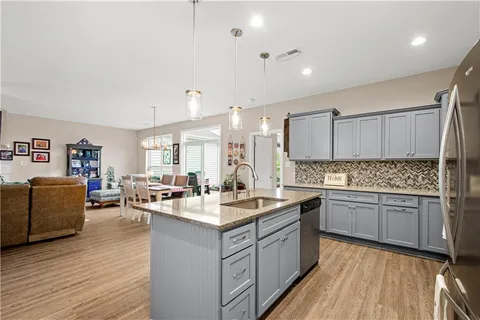 a kitchen with a sink stove and wooden cabinets