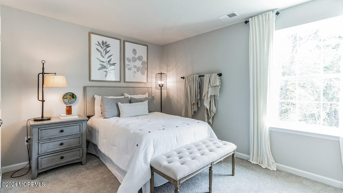 36 Penny Lane Neptune, NJ 07753 - Photo 11 of 20 a bedroom with a bed and a dresser