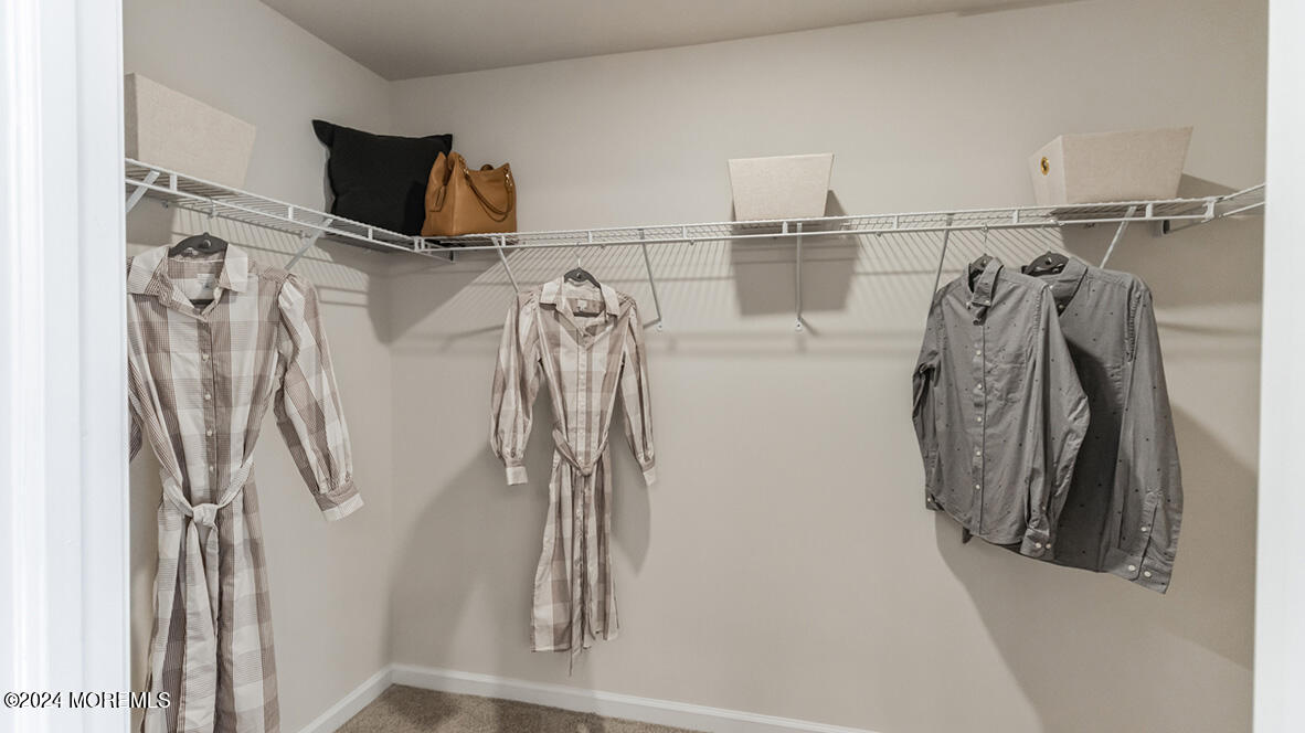 36 Penny Lane Neptune, NJ 07753 - Photo 15 of 20 a view of walk in closet with clothes and shoes
