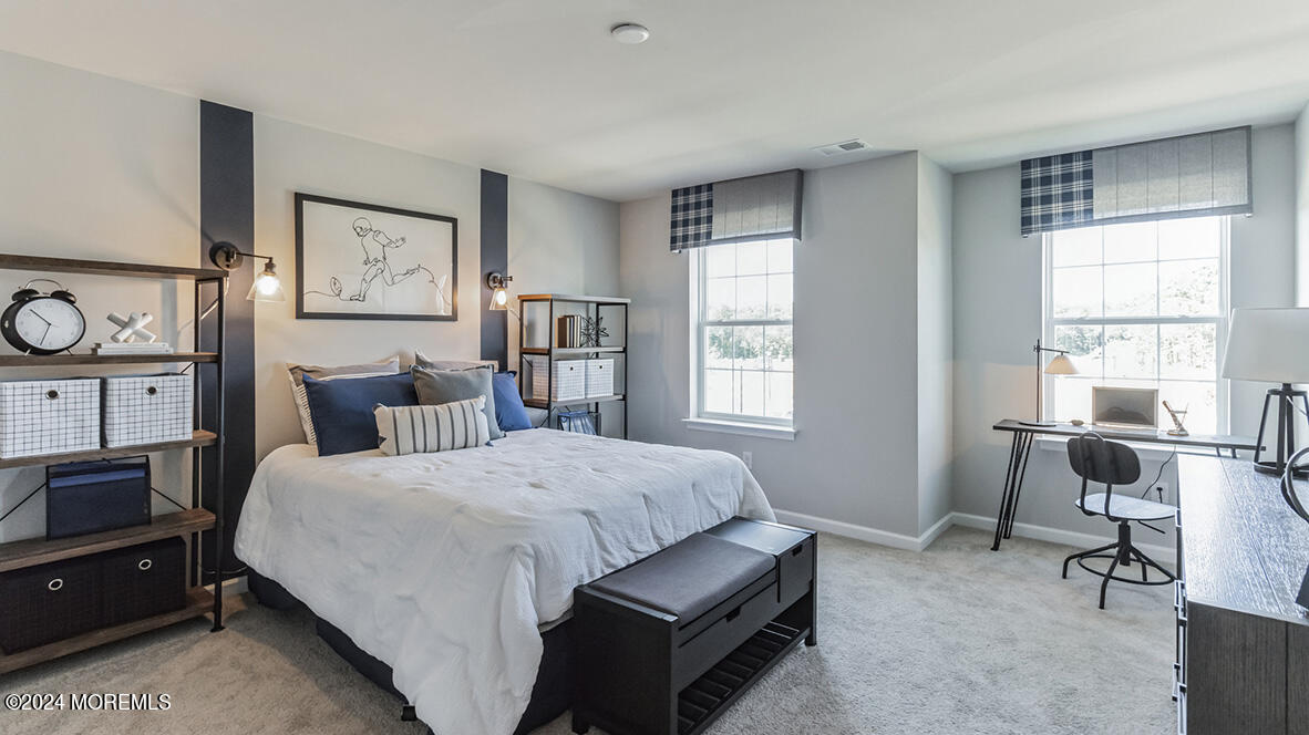 36 Penny Lane Neptune, NJ 07753 - Photo 17 of 20 a bedroom with a bed a table and chair