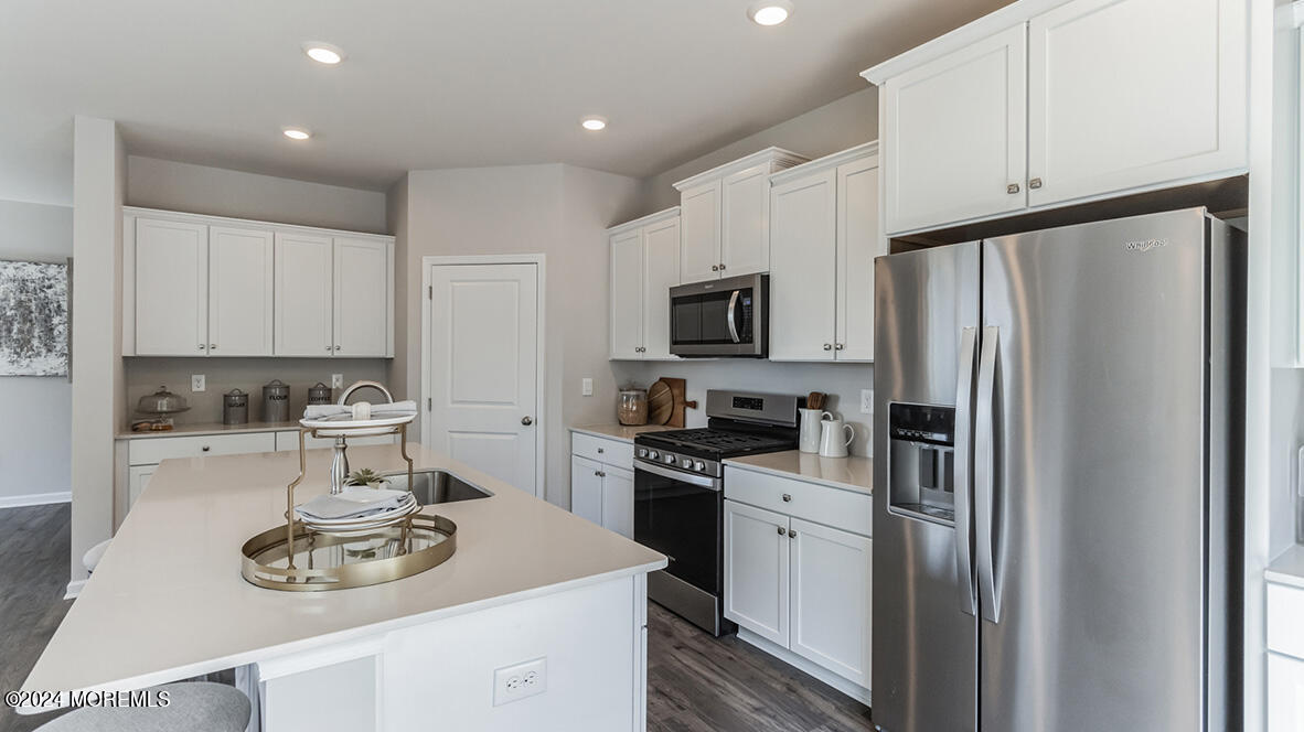 36 Penny Lane Neptune, NJ 07753 - Photo 5 of 20 a kitchen with stainless steel appliances a refrigerator stove and white cabinets