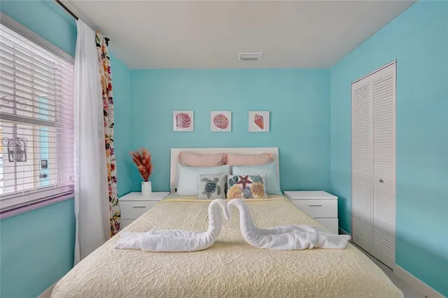 a bedroom with a bed and a window