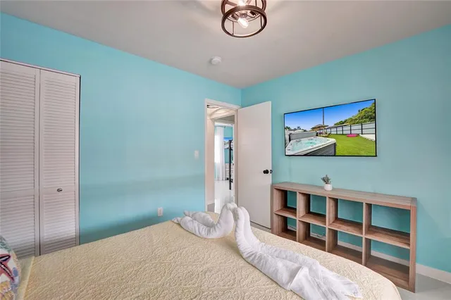 a bedroom with a bed and a chandelier