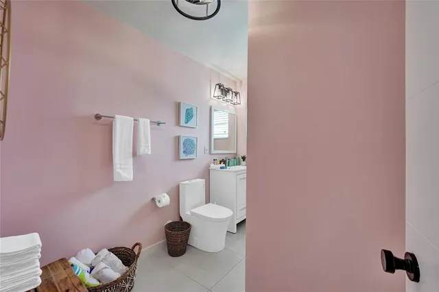 a white toilet sitting next to a bathroom sink