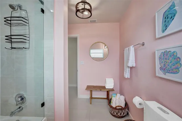 a bathroom with a toilet and a shower