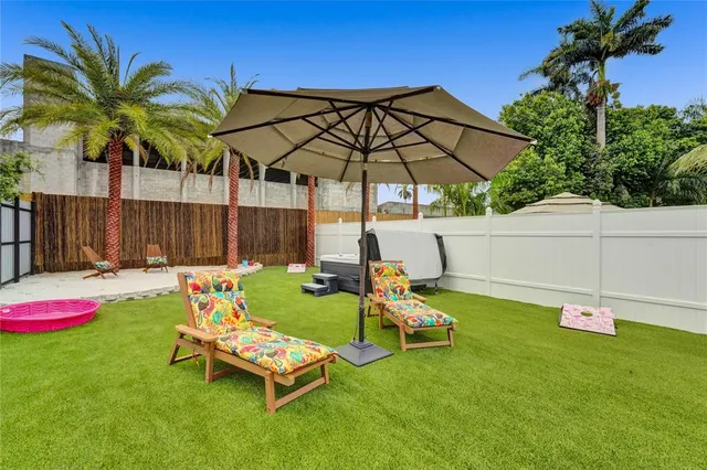 a backyard of a house with table and chairs