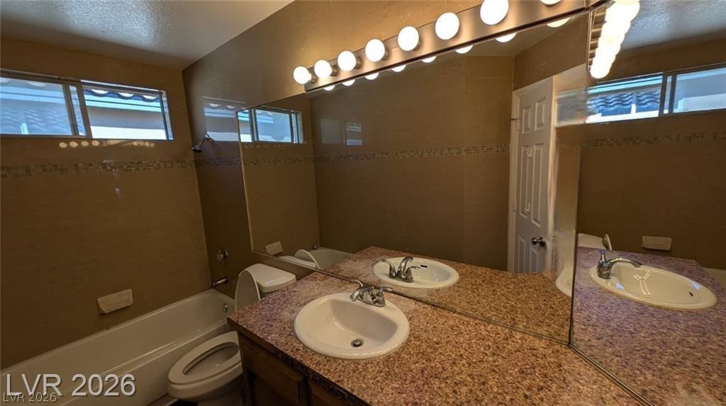 2670 Ridgewater Circle Henderson, NV 89074 - Photo 16 of 22 This bathroom features a functional vanity with dual sinks, offering ample space and convenience.