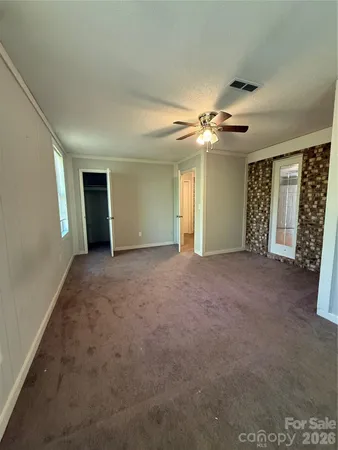 a view of an empty room with a fireplace